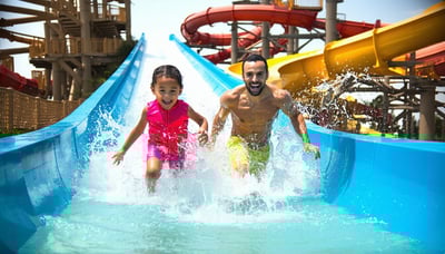 Family enjoying water slides at Aquaventure World Dubai Family enjoying water slides at Aquaventure World Dubai